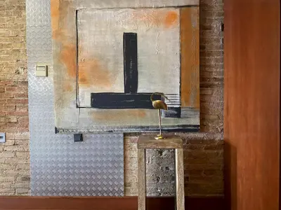 a painting on a wall with a table in front at Luminous Designer Loft Style Apt Eixample Views By MyRentalHost in Barcelona