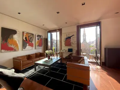 a living room with a couch and a table at Luminous Designer Loft Style Apt Eixample Views By MyRentalHost in Barcelona