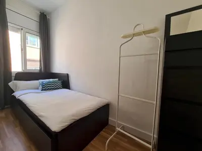 a small bedroom with a bed and a dresser at WALK to CAMP NOU - Wi-Fi AC 3 Bed by MyRentalHost in Hospitalet de Llobregat