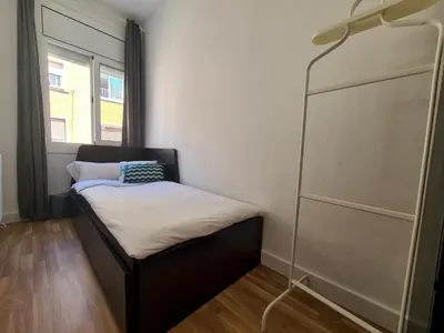 a small room with a bed and a window at WALK to CAMP NOU - Wi-Fi AC 3 Bed by MyRentalHost in Hospitalet de Llobregat