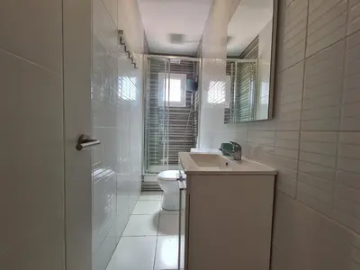 a white bathroom with a sink and a toilet at WALK to CAMP NOU - Wi-Fi AC 3 Bed by MyRentalHost in Hospitalet de Llobregat