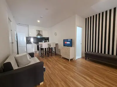 a living room with a couch and a television at WALK to CAMP NOU - Wi-Fi AC 3 Bed by MyRentalHost in Hospitalet de Llobregat