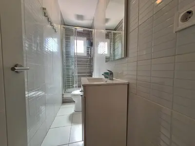a white bathroom with a sink and a toilet at WALK to CAMP NOU - Wi-Fi AC 3 Bed by MyRentalHost in Hospitalet de Llobregat