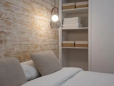 a bedroom with a bed and a shelf with towels at ´Vicens Gem´ Private terrace HS Wi-Fi in Gracia by MyRentalHost in Barcelona