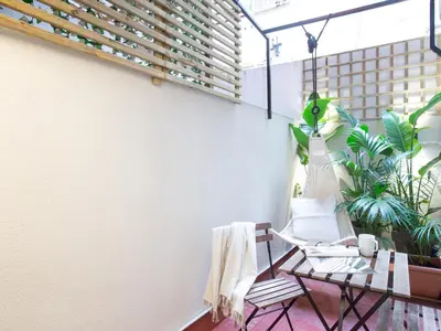 a balcony with a table and chairs and plants at ´Vicens Gem´ Private terrace HS Wi-Fi in Gracia by MyRentalHost in Barcelona