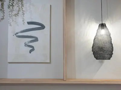 a wall with two paintings and a hanging light at ´Vicens Gem´ Private terrace HS Wi-Fi in Gracia by MyRentalHost in Barcelona