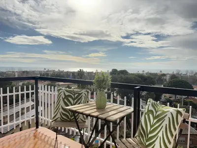 a patio with a table and chairs on a balcony at Atico Isabel in Castelldefels