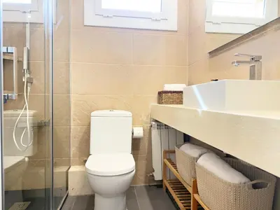 a bathroom with a toilet and a sink at Atico Isabel in Castelldefels