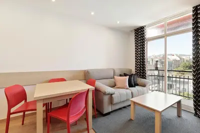 a living room with a couch and a table and chairs at El balcón de Sagrada Familia in Barcelona