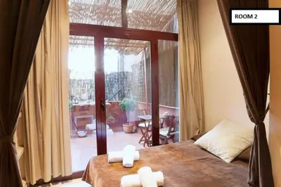 a bedroom with a bed with two towels on it at Family apartment Plaza España in Barcelona
