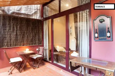 a room with a table and chairs and a bedroom at Family apartment Plaza España in Barcelona