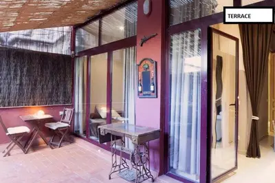 a house with a table and a bench on a patio at Family apartment Plaza España in Barcelona