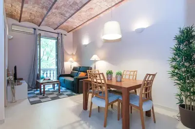 a living room with a table and chairs and a couch at Family apartment Plaza España 2 in Barcelona