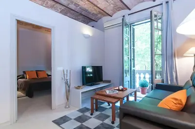 a living room with a couch and a tv at Family apartment Plaza España 2 in Barcelona