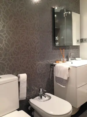 a bathroom with a toilet and a sink at The White Lilies in Pineda de Mar