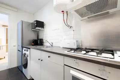 a kitchen with a stove top oven next to a sink at Stay U-nique Apartment Rossello II in Barcelona