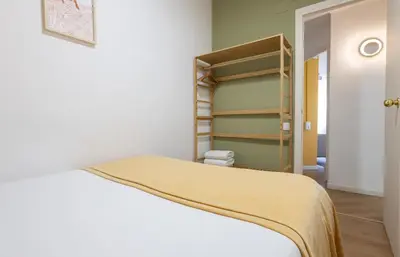 a bedroom with a bed and a book shelf at Stay U-nique Apartment Rossello II in Barcelona