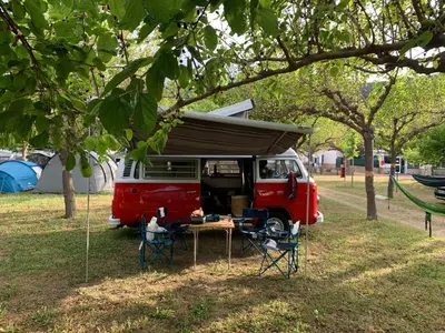 a red van with a tent and a table and chairs at Retro VW Kombi T2 Campervan in Hospitalet de Llobregat
