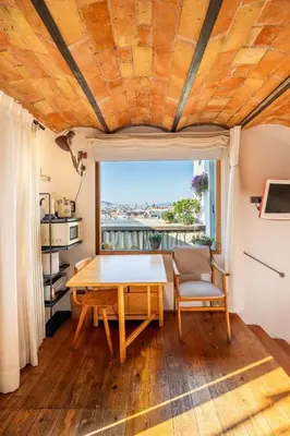 a table and chairs in a room with a window at Apartment with Terrace Views of BCN in Barcelona