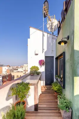 a stairway with plants and a door on a building at Apartment with Terrace Views of BCN in Barcelona