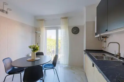 a kitchen with a table and chairs and a sink at Housalia Casa del Mar en Vila Olímpica in Barcelona