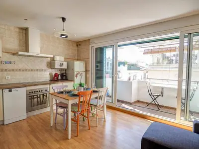 a kitchen and dining room with a table and chairs at Carmen Apartment by Hello Homes Sitges in Sitges