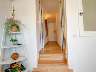 a hallway with white shelves and a stairway at Carmen Apartment by Hello Homes Sitges in Sitges