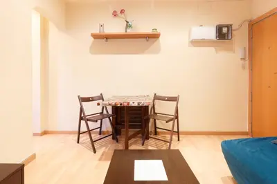 a small living room with a table and chairs at Apartment Bed&BCN Sant Andreu II in Barcelona