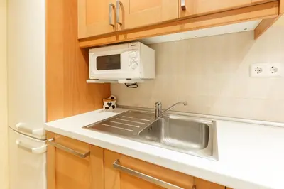 a kitchen with a sink and a microwave at Apartment Bed&BCN Sant Andreu II in Barcelona