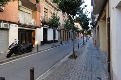 a motorcycle parked on the side of a street at Apartment Bed&BCN Sant Andreu II in Barcelona