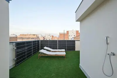 a balcony with a bench and green grass at YOUR HOME- Apartment Camp Nou 2a in Hospitalet de Llobregat