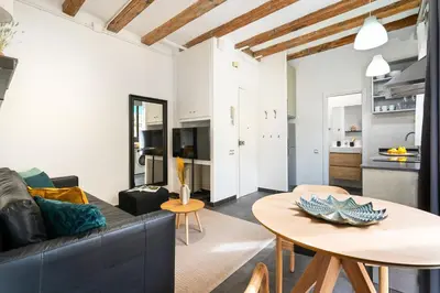 a living room with a couch and a table at Lodging Apartments Almirall Beach 22 in Barcelona