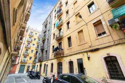 a city street with buildings and motorcycles parked on the street at Lodging Apartments Almirall Beach 22 in Barcelona