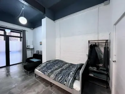 a bedroom with a bed and a chair at Studio Sagrada Familia in Barcelona