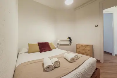 a bedroom with a large bed with towels on it at Plaza España 238 in Barcelona