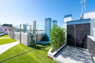 a view of the backyard of a house with grass at Hauzify I Apartaments Voramar in San Pol de Mar