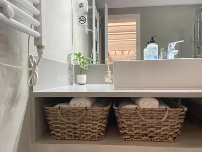 two baskets under a kitchen counter with a sink at Lazy Donkey Sagrada Familia in Barcelona