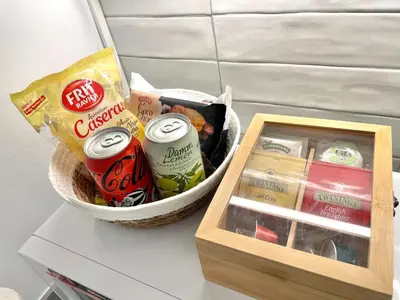 a basket filled with food and a box of snacks at Lazy Donkey Sagrada Familia in Barcelona