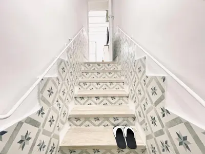 a staircase with a pair of shoes on the floor at Lazy Donkey Sagrada Familia in Barcelona
