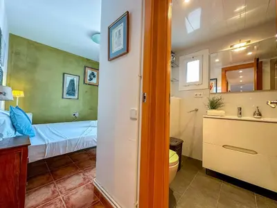 a bathroom with a bed and a toilet and a sink at Sira House by Hello Homes Sitges in Sitges