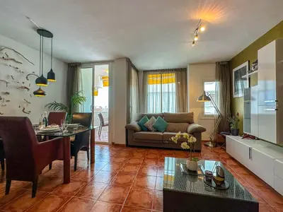 a living room with a couch and a table at Sira House by Hello Homes Sitges in Sitges