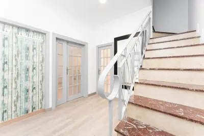 an empty room with stairs in a house at La Sagrera House in Barcelona