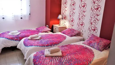 a room with three beds with pillows on them at ALEXANDRA´s BEACH-PORT in Badalona