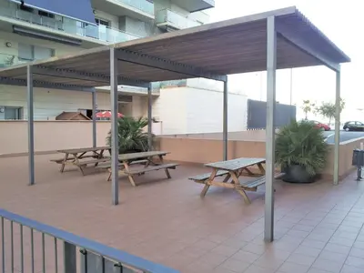 a group of picnic tables on a patio at ALEXANDRA´s BEACH-PORT in Badalona