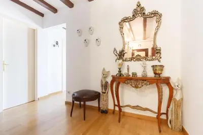 a room with a table and a mirror on the wall at Apartment Eixample Comfort in Barcelona