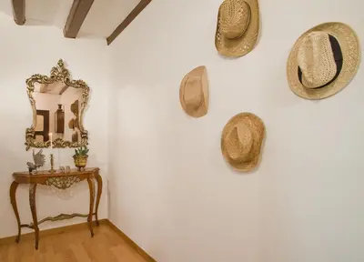 a room with hats on the wall and a table at Apartment Eixample Comfort in Barcelona