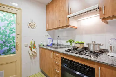 a kitchen with a stove and a sink at Apartment Eixample Comfort in Barcelona