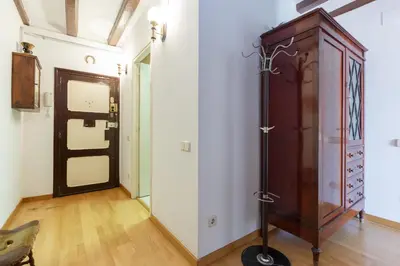 a room with a wooden cabinet and a door at Apartment Eixample Comfort in Barcelona