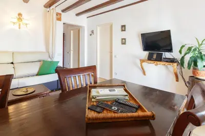 a living room with a table with remote controls at Apartment Eixample Comfort in Barcelona