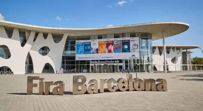 a large building with a sign in front of it at Cozy and sunny penthouse Fira BCN in Hospitalet de Llobregat